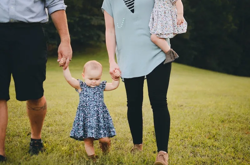 parents take baby for a walk in the nature