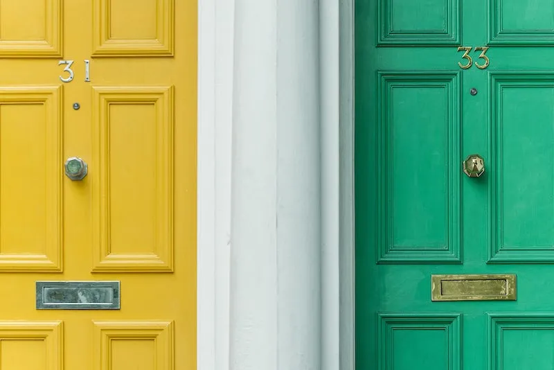 Two neighboring front doors, side-by-side
