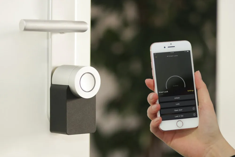 Person locks a door using a smartphone app