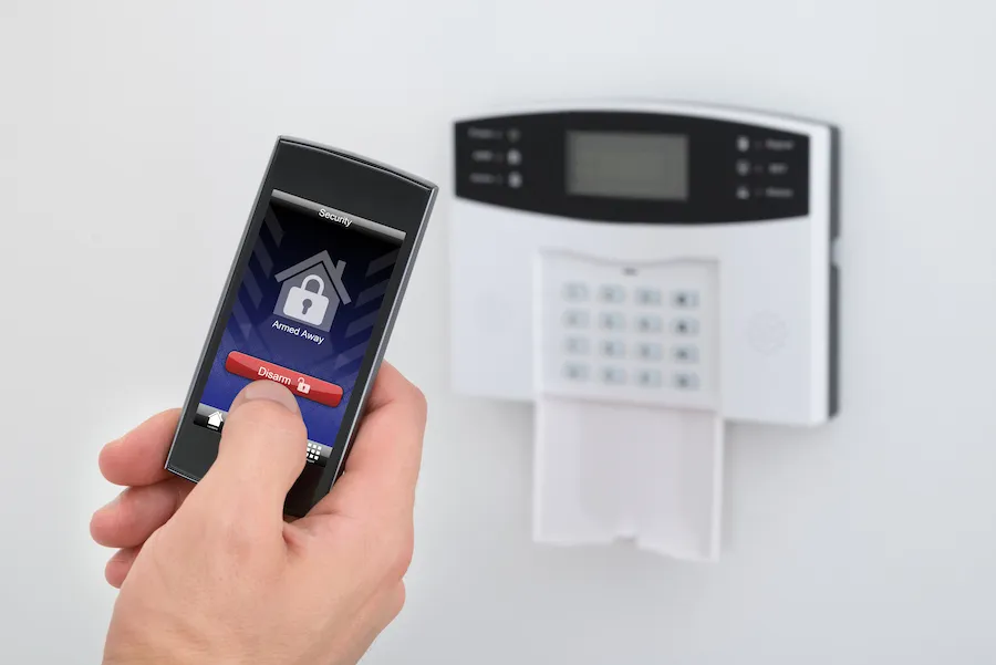Security Alarm Keypad With Person Disarming The System With Remote Controller