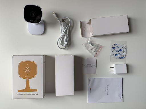The contents included with AlfredCam: the camera, micro USB cable, charger, Quick Start guide, two screws with wall mounts, and alignment/mounting stickers.
