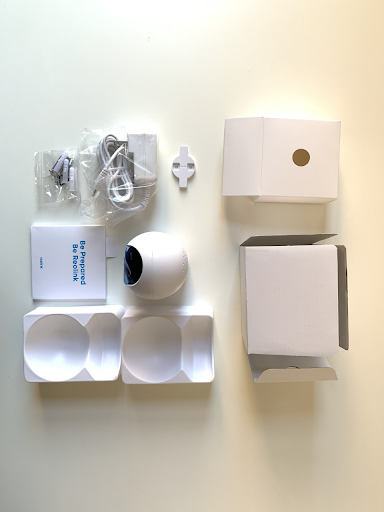 The contents of the Reolink E1 Pro. The camera is kept in a white plastic shell.
