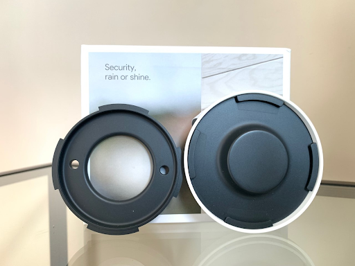 The underside of the Nest Cam (right) next to the mounting plate (left)