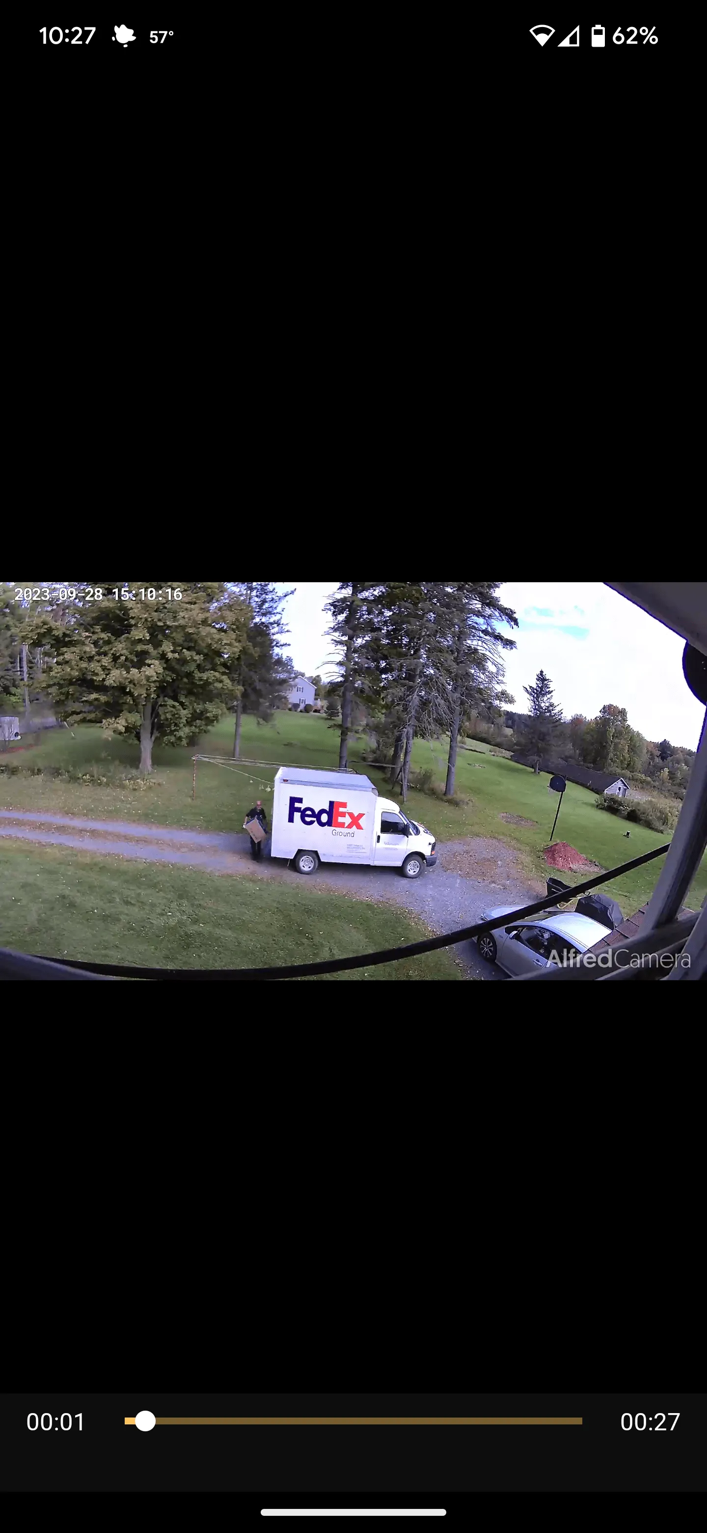 AlfredCamera clip of a FedEx truck and a driver carrying a package in a driveway.