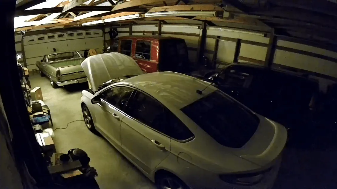 AlfredCam Plus night vision footage of a garage with several parked cars
