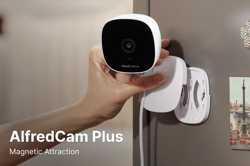 A hand attaching AlfredCam Plus to a metal surface with its magnetic mount