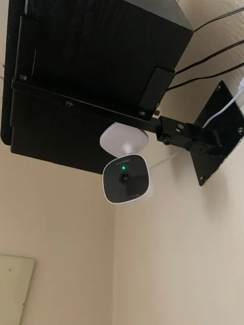 AlfredCam Plus mounted in a upside down position under a TV.