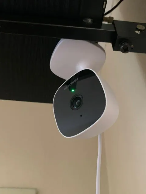 AlfredCam Plus mounted in a upside down position under a TV (close up).