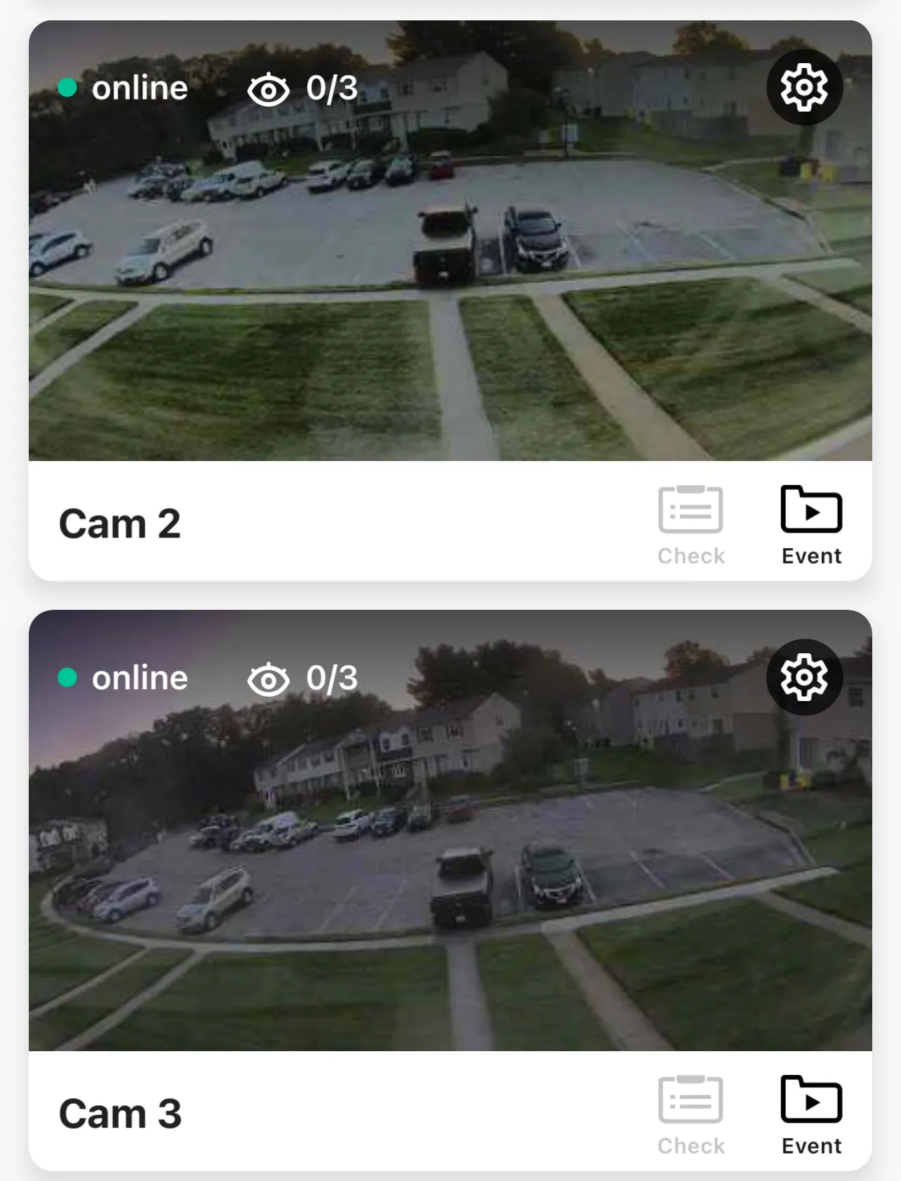 AlfredCamera app showing two outdoor camera views of a parking lot and lawn at dusk